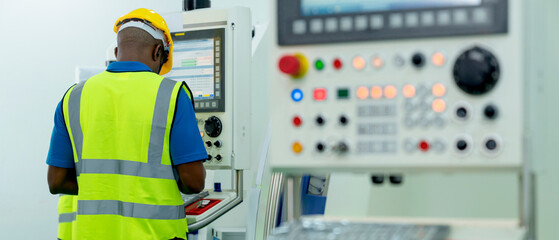 young caucasian technicians work manage  inspecting with control screen computer the work process of industrial CNC metal machining in clean room On High-Tech modern Factory business industrial