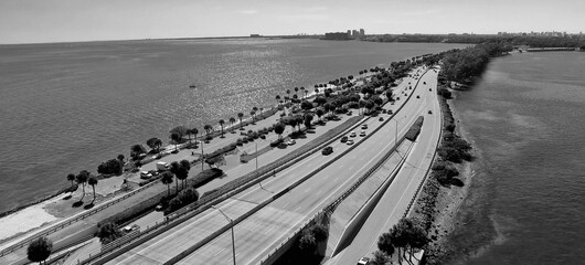 Wall Mural - Traffic over Rickenbacker Causeway on a sunny day, aerial view from drone in slow motion.