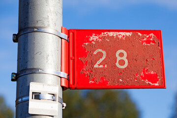 red sign with white text number twenty-eight