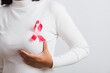 © sorapop - Breast cancer awareness healthcare and medicine concept. Close up Asian woman wear t-shirt she have pink breast cancer awareness ribbon on chest she hold breast by hand, isolated on white background