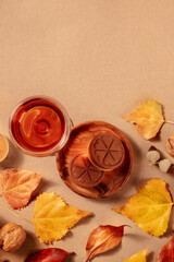 Poster - Sweet wine, biscuits, and autumn leaves, shot from the top with a place for text on a brown background