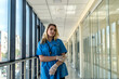 © RomanR - Pretty nurse in blue uniform with stetoscope indoors in modern clinic