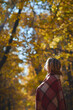 © Александр Гаврилычев - Portrait of a young happy beautiful woman in a brown hat and red plaid walks in the autumn sunny park at sunset. Inspiration, autumn mood, travel, beauty of nature, forest.