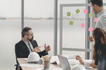 Engineers team meeting for architectural project. architects discussing blueprint with construction manager in office worker conference site. Construction Concept