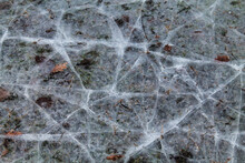 Layer Of Ice Cracked On The Surface Of A Field