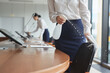 © Seventyfour - Cropped shot of elegant young women cleaning conference room with sanitizing spray while preparing for business event in office, copy space