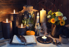 Mysterious Still Life With Open Diary Book And Black Candles On Witch Table