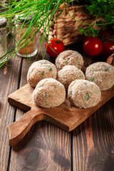 Canvas Print - Raw meatballs rolled in a crispy bun prepared for baking