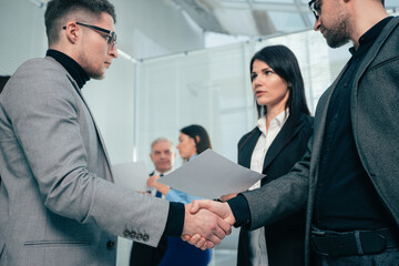 Wall Mural - smiling business partners shaking hands with each other.