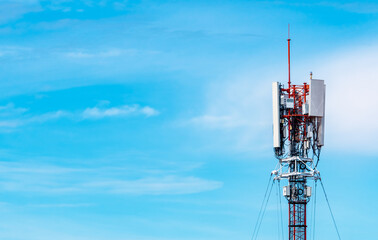 Telecommunication tower with blue sky and white clouds background. Antenna on blue sky. Radio and satellite pole. Communication technology. Telecommunication industry. Mobile or telecom 4g network.