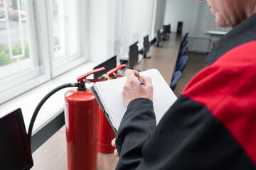 Wall Mural - engineer professional are checking a fire extinguisher using clipboard or checking industrial fire c