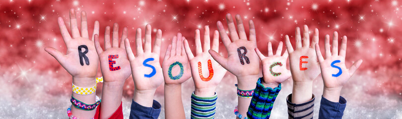 Wall Mural - Children Hands Building Colorful English Word Resources. Red Snowy Christmas Winter Background With Snowflakes And Sparkling Lights