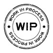 Grunge black WIP work in process word round rubber seal stamp on white background