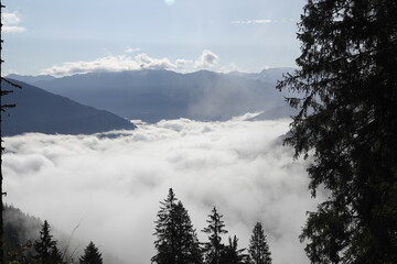 blue clear sky on the mountains with view of a foggy valley and the alps