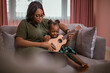African mother and daughter playing ukulele.