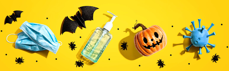 Masks and sanitizer bottle with Halloween objects - healthcare and hygiene concept