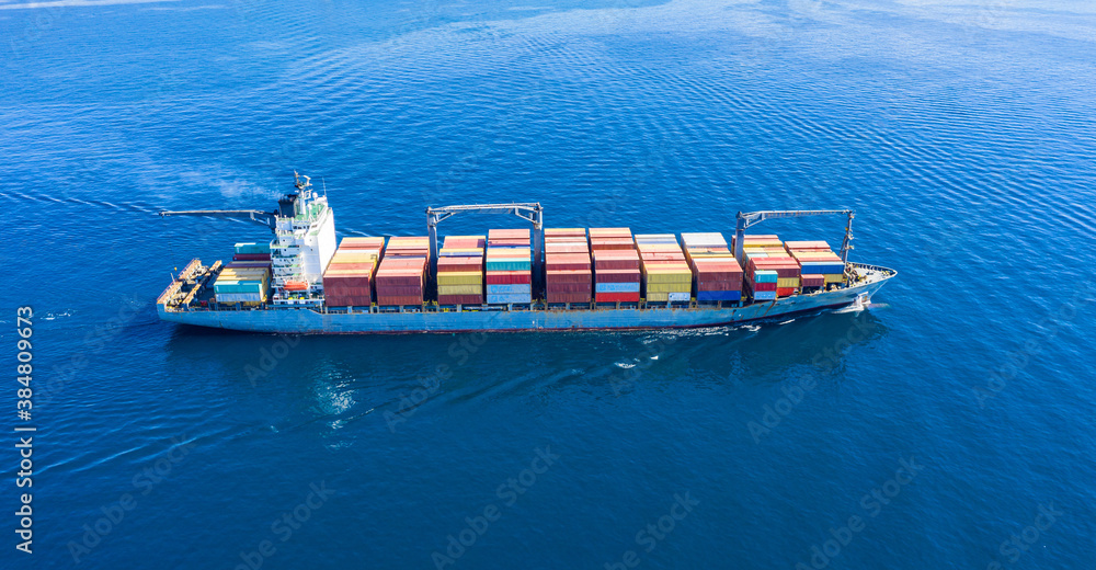 Cargo ship full loaded with containers, blue sea background - obrazy, fototapety, plakaty 