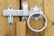 Traditional metal gate latch with ring handle closeup