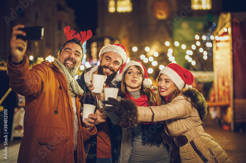 Friends Take Selfie in Downtown At Holiday Night