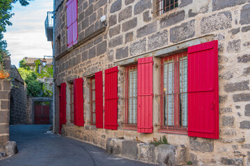 Wall Mural - Small street at Agde Centre with old Buildings with red windows