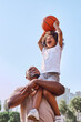 © Afshar Tetyana - Caring dad holding his kid up while playing basketball