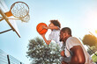 © Afshar Tetyana - Helpful father lifting his kid up to basketball hoop