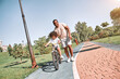 © Afshar Tetyana - Afro-American child learning to ride a bicycle with his dad