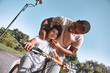 © Afshar Tetyana - African American man putting a helmet on his kid head