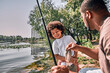 © Afshar Tetyana - Afro-American dad and his son having successful fishing day