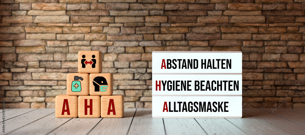 German acronym AHA with a lightbox showing the three rules in a pandemic HOLD DISTANCE, FOLLOW HYGIENE, COMMUNITY MASKS on in front a brick wall - obrazy, fototapety, plakaty 