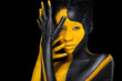 © Mike Orlov - Face art. Woman with black and yellow body paint. Young african girl with colorful bodypaint. An amazing model with yellow makeup. Closeup face.
