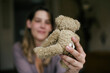 © VegterFoto/Stocksy - Mother Holding Small Stuffed Teddy Bear