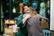 © VegterFoto/Stocksy - Toy Shop Owner Embracing her Friend Outside Store