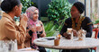 © IVAN GENER/Stocksy - Muslim women talking and drinking coffee
