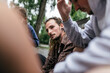 © VegterFoto/Stocksy - Young Man With Dreadlocks Listening To Friends Plan Game