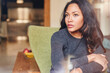 © IVAN GENER/Stocksy - Young woman sitting at home