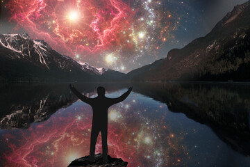 Wall Mural - exploding supernova reflected in the mountain lake with male silhouette in foreground