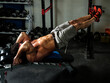 © Riley JB/Stocksy - A muscular man doing ab workout.