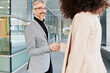 © IVAN GENER/Stocksy - Businesspeople shaking hands outside