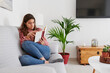© IVAN GENER/Stocksy - Young woman reading at home