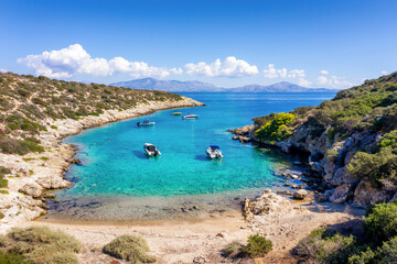 Wall Mural - a small beach on the little island of fleves, close to athens, with turquoise sea and people enjoyin