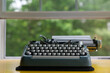 © Lauren Lee/Stocksy - Typewriter sitting on desk