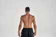 © Svitlana - Rear view of muscular man with naked posing isolated over grey background, studio shot