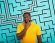 Confused Man has a big maze to solve. Concept of options, confusion, decision.