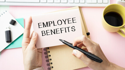 EMPLOYEE BENEFITS, message on business card shown by a businesswoman