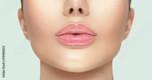 Beautiful young woman\'s lips closeup. Plastic surgery, fillers, injection. Part of the model girl face, youth concept. Perfect healthy skin. Natural make-up. Chin. Youth and beauty. Health care
