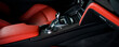Leinwandbild Motiv Modern luxury car Interior - steering wheel, shift lever and dashboard. Car interior luxury inside. Steering wheel, dashboard, speedometer, display. Red and black leather cockpit
