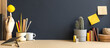 Leinwandbild Motiv Creative desk with notebook, desk objects, office supplies, books, and cactus on a dark blue background.	
