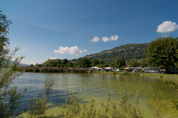 Wall Mural - View of the gulf of Agno and a campsite in Switzerland