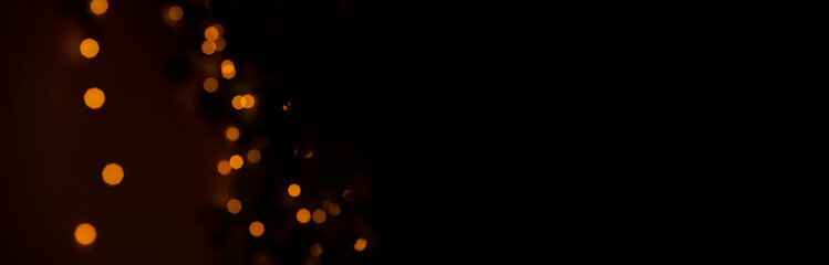 garland illumination festive simple background wallpaper pattern concept of yellow lighting bokeh on black empty copy space for your text panoramic format